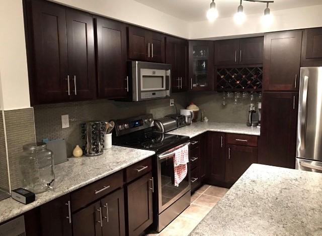 Beautiful kitchen designed by expert ProCabinets design team featuring The Builder Collection